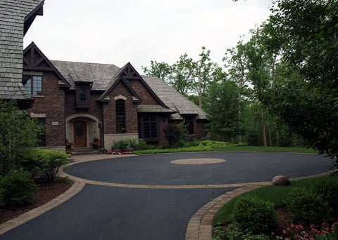 Large circular driveway with brick and ashphalt 