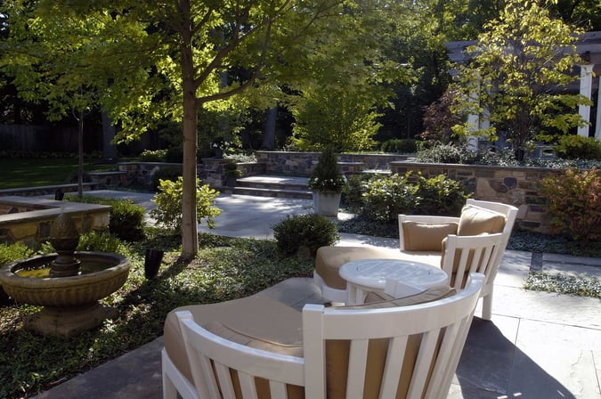 backyard patio with seating looking at fountain