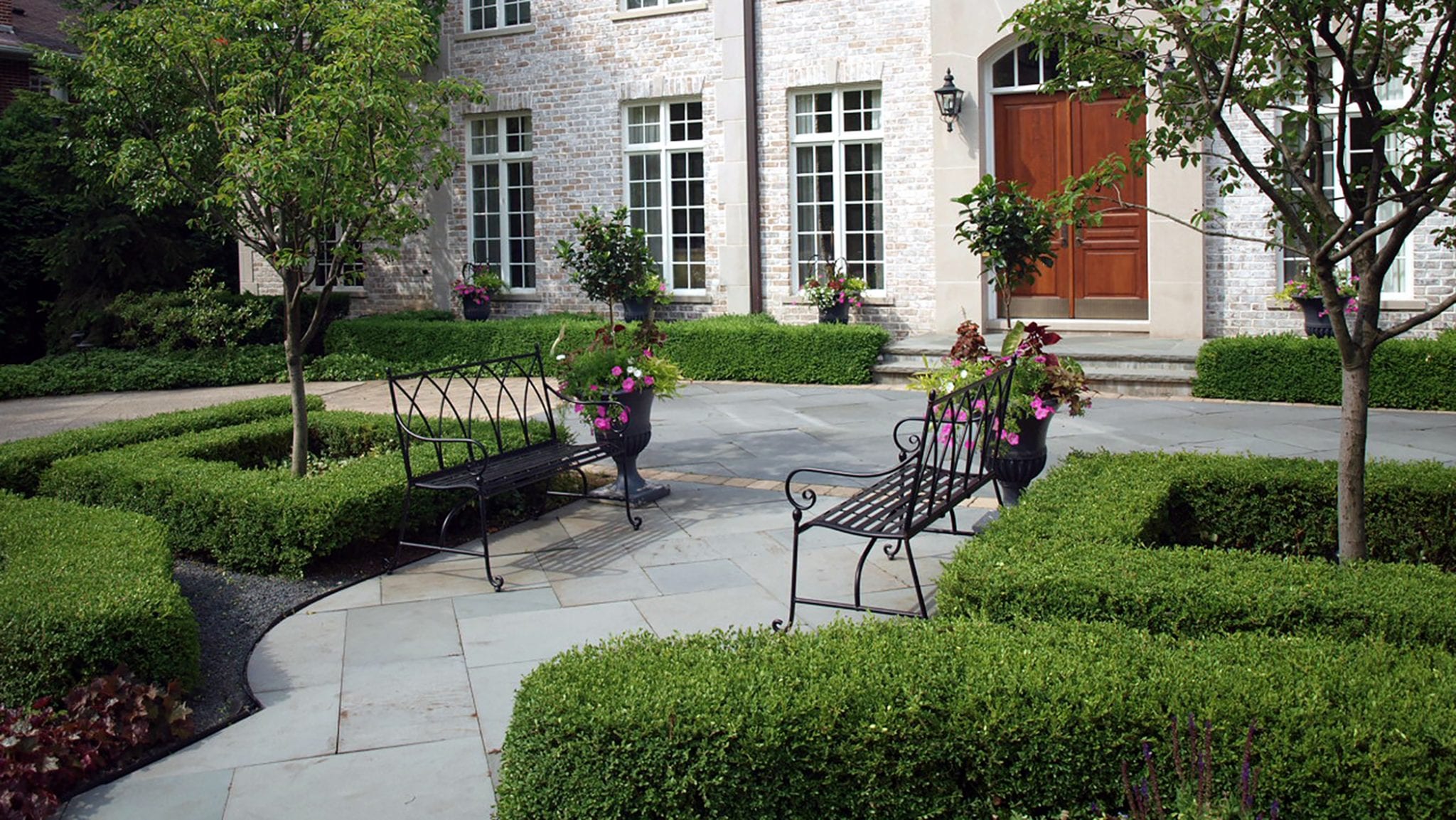 front of house with herringbone walkway leading to front door