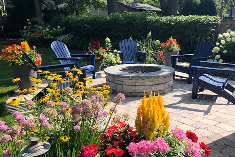 Flower ring containers next to firepit patio