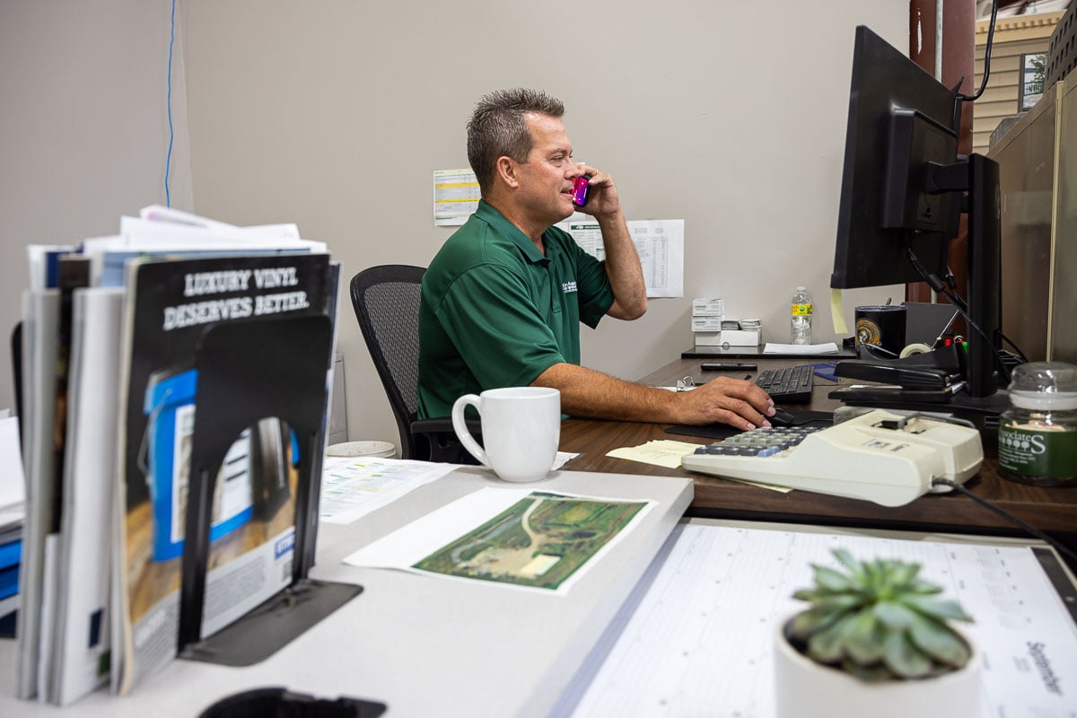 Account manager at desk on computer and on phone