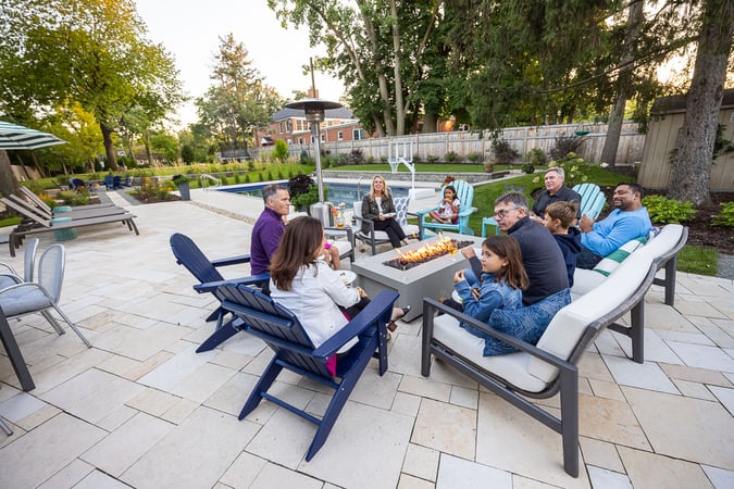 Residential landscape design family sitting by fire on patio 10