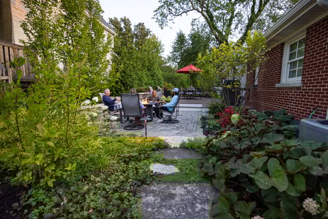 residential landscape design family sitting around fire-1