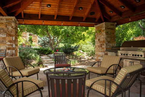 Residential backyard pergola with brick columns and outdoor kitchen