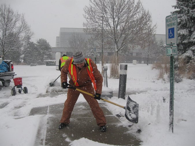 crew shoveling snow outside during storm 