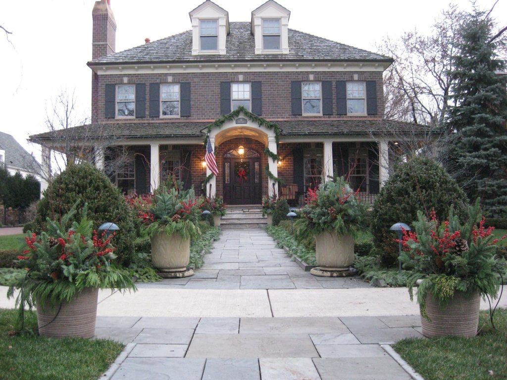 front of house and planters decorated for holidays 