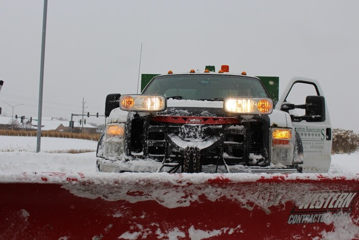 snow truck with lights on plowing snow