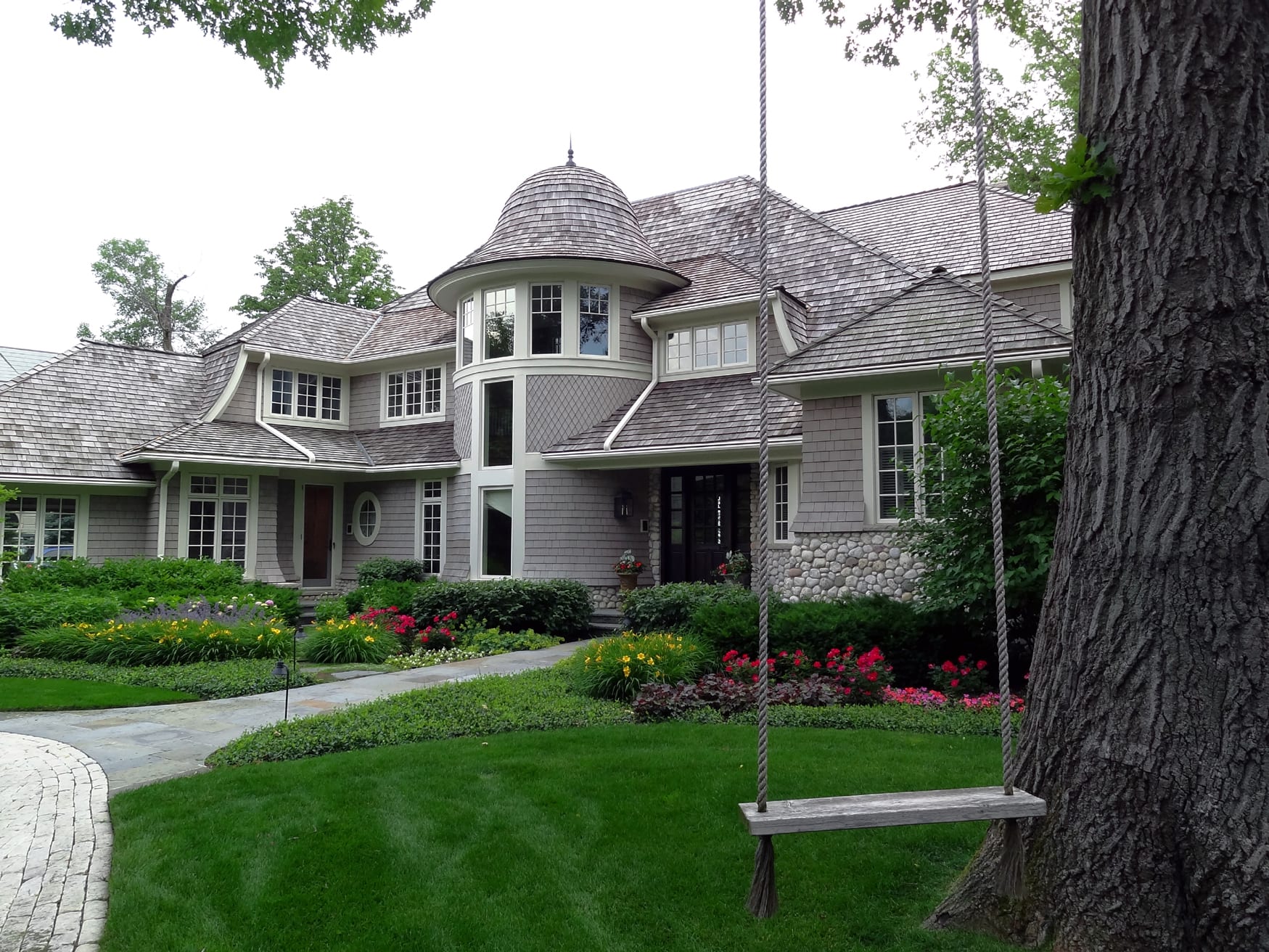 front yard with swing overlooking garden beds