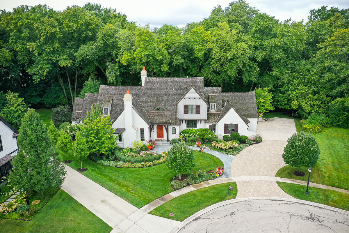 Front of nice house with green lawn, landscaping and paver driveway 1