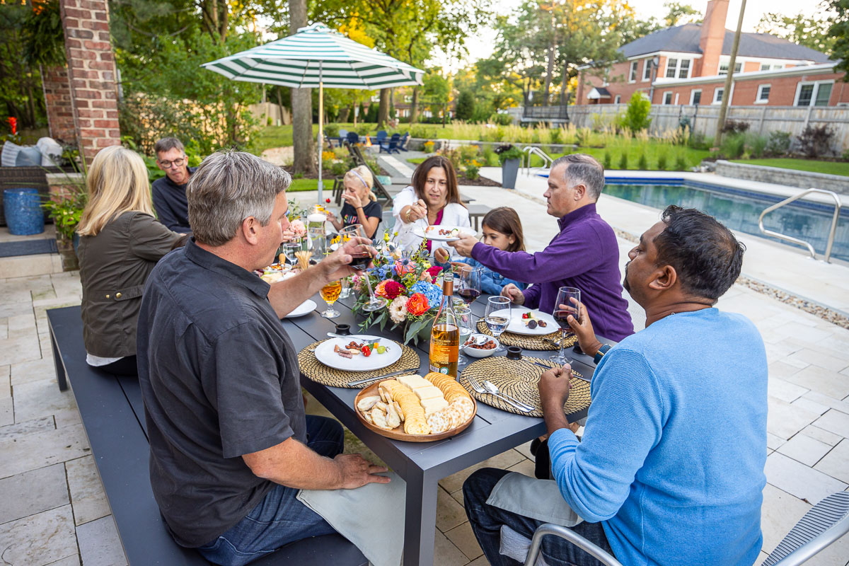 Residential landscape design family eating together on patio 5