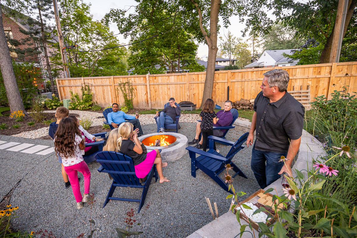 Residential landscape design family sitting around fire pit 10