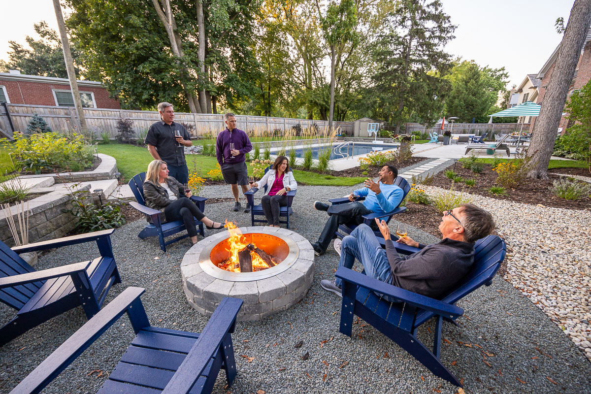 Residential landscape designfamily sitting around fire pit 1