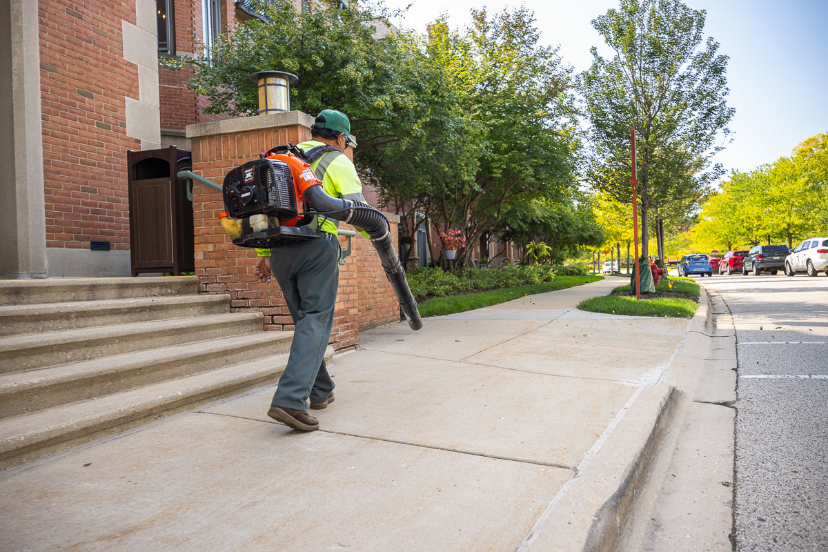 commercial landscape maintenance retirement crew clearing off sidewalk 3