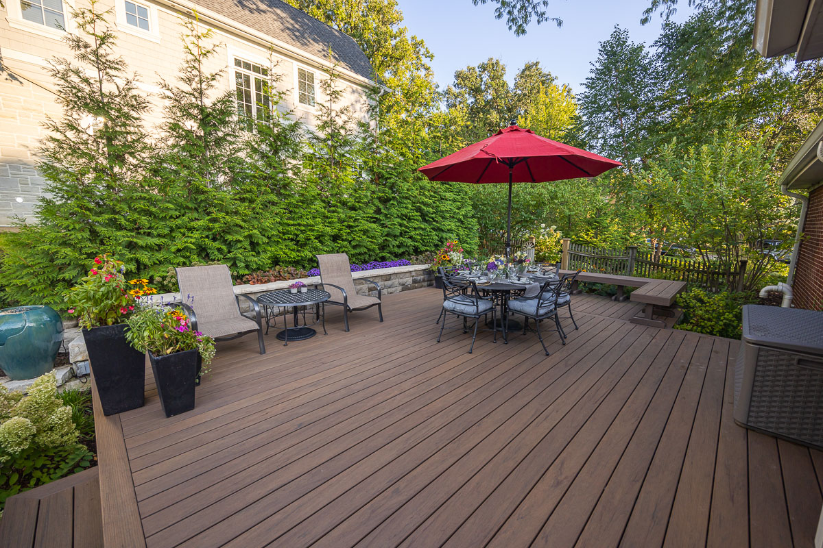 residential landscape design deck with seating area and retaining wall