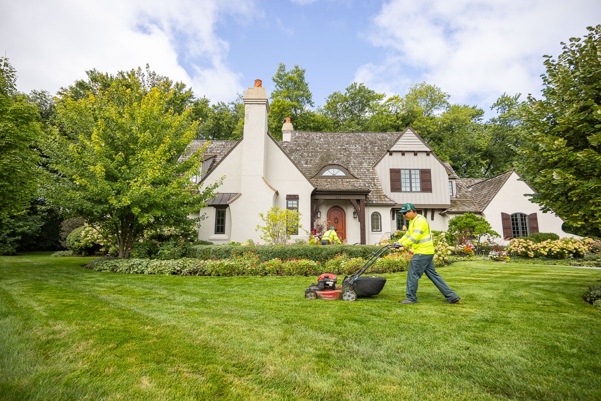 residential maintenance crew mowing front lawn 1