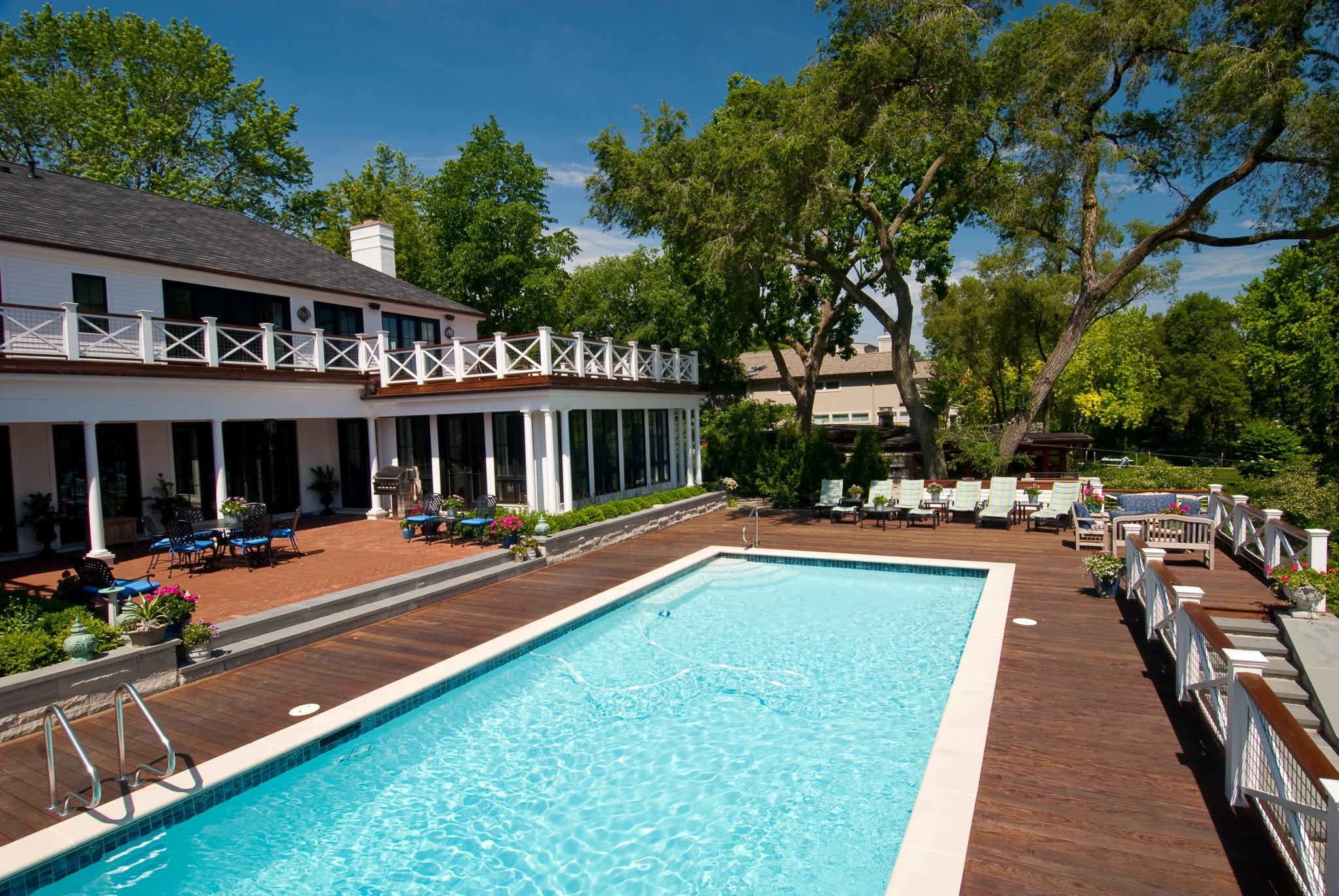 backyard pool with wood deck surround and patio