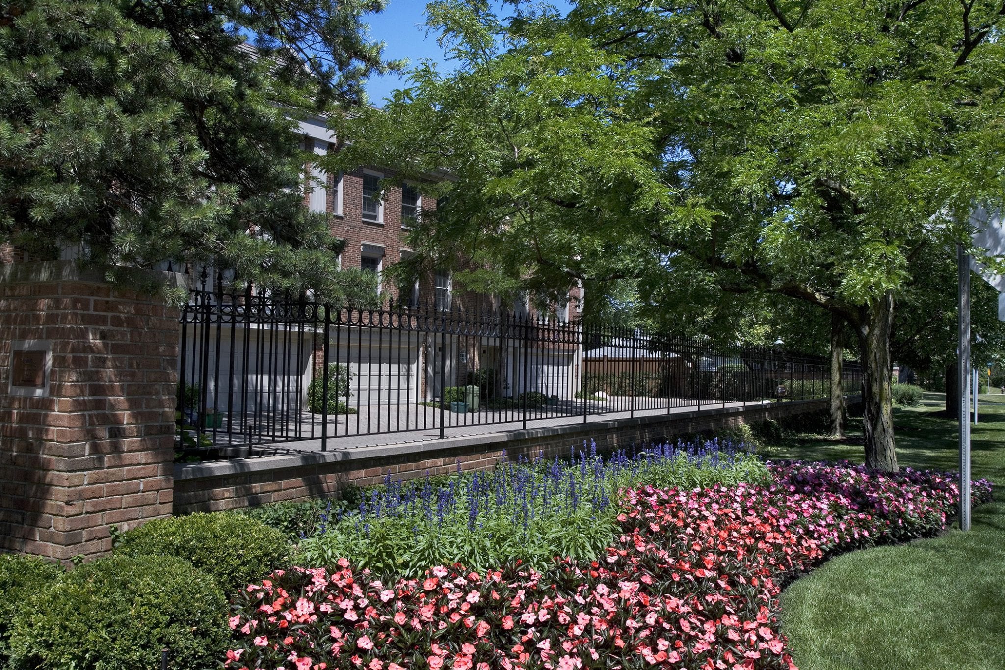 flower beds near town homes and iron fence 