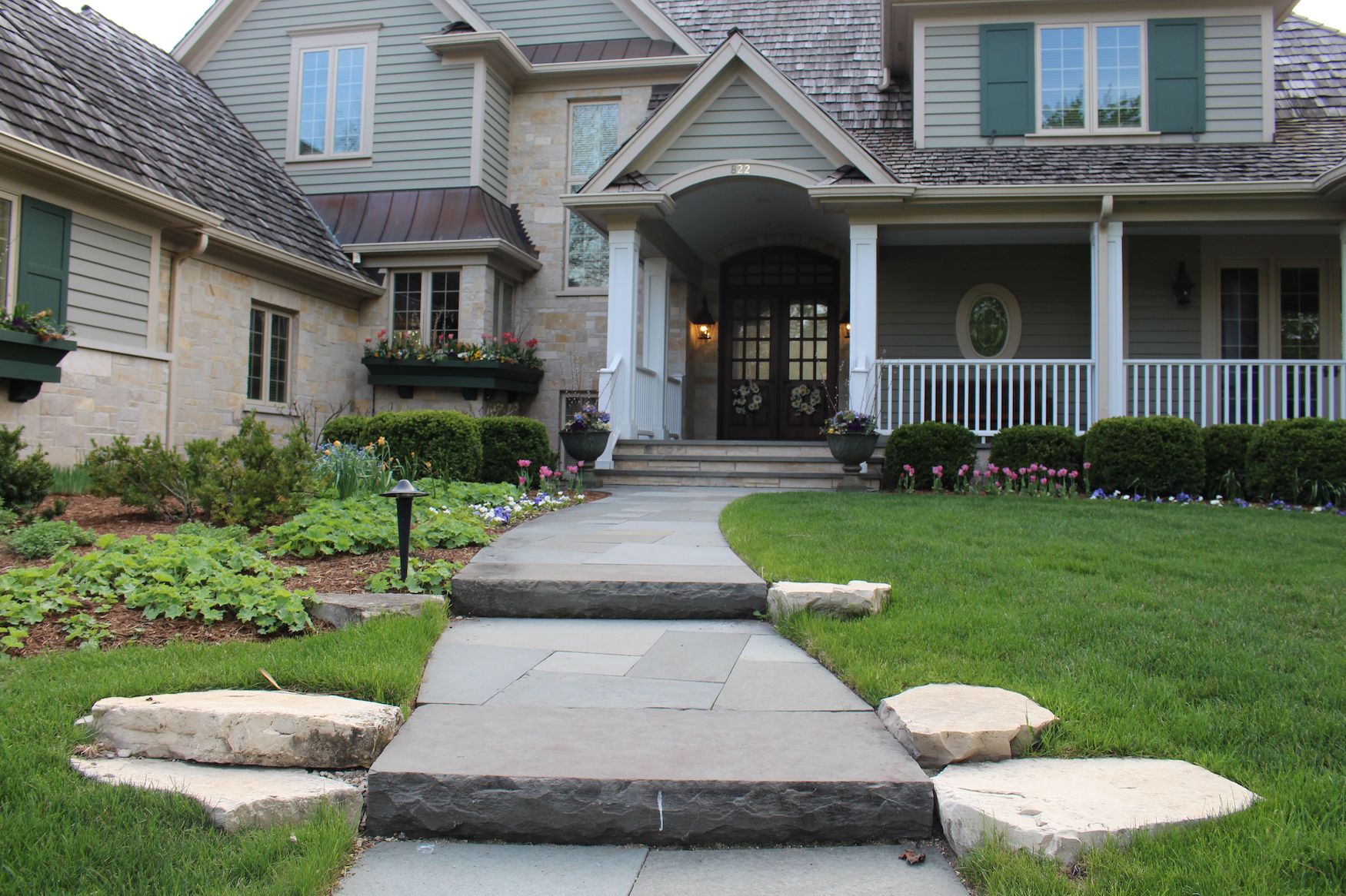 front of house with stone steps leading to front door