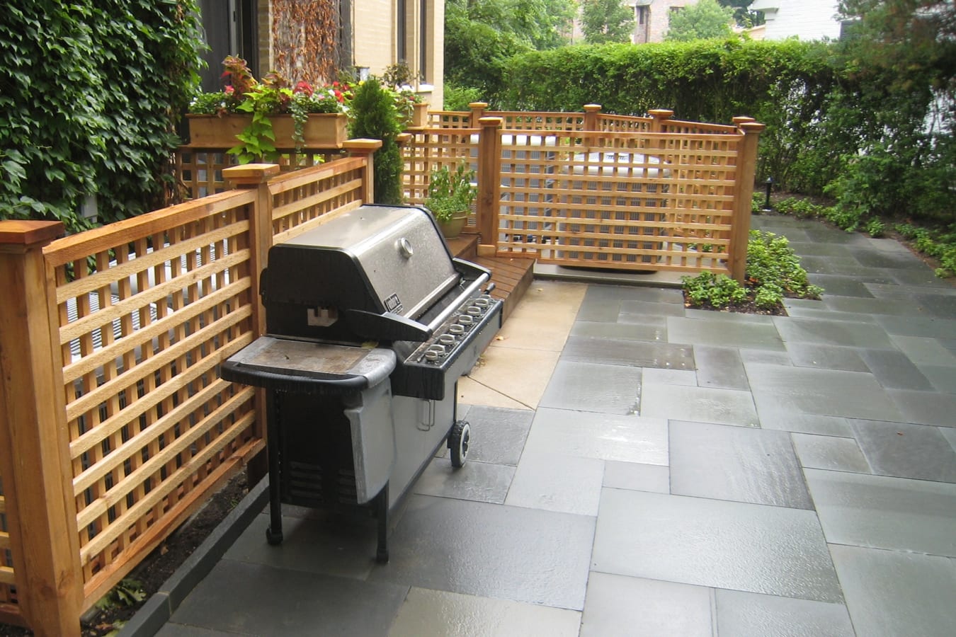 wood fence around patio and grill